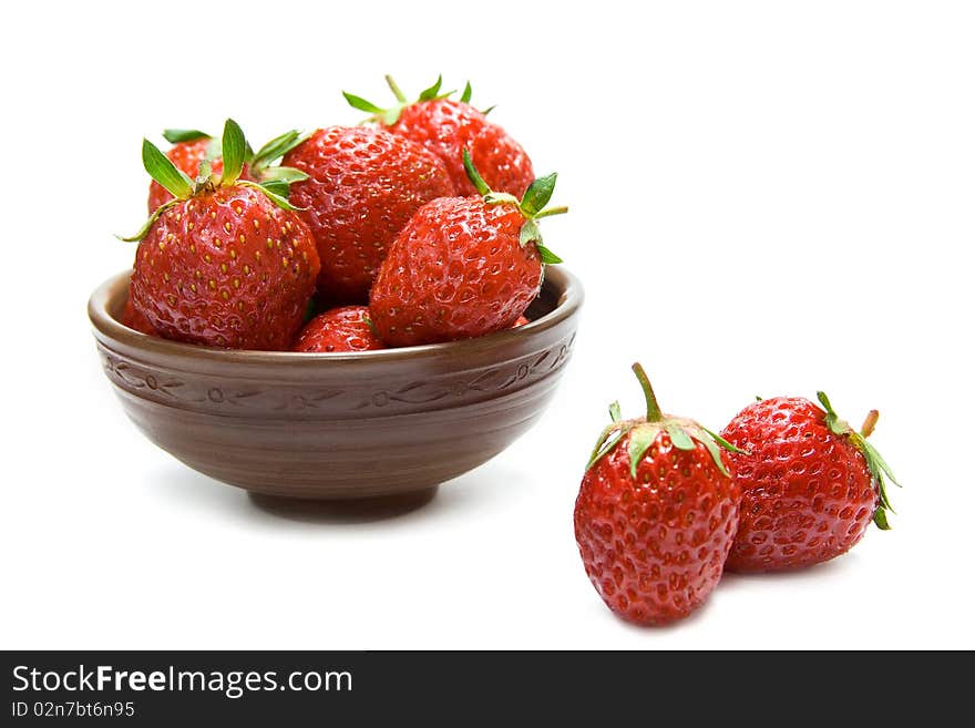 Fresh strawberries in the bowl isolated on white. Fresh strawberries in the bowl isolated on white