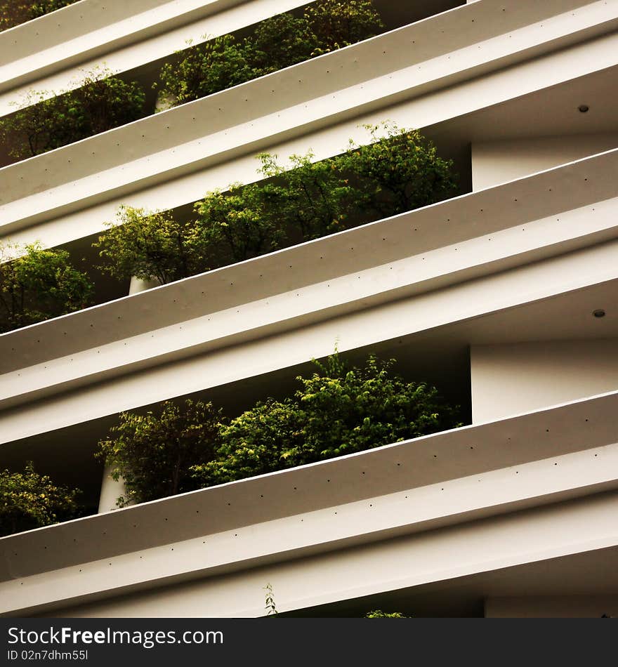 White facade and balconies with trees. White facade and balconies with trees.