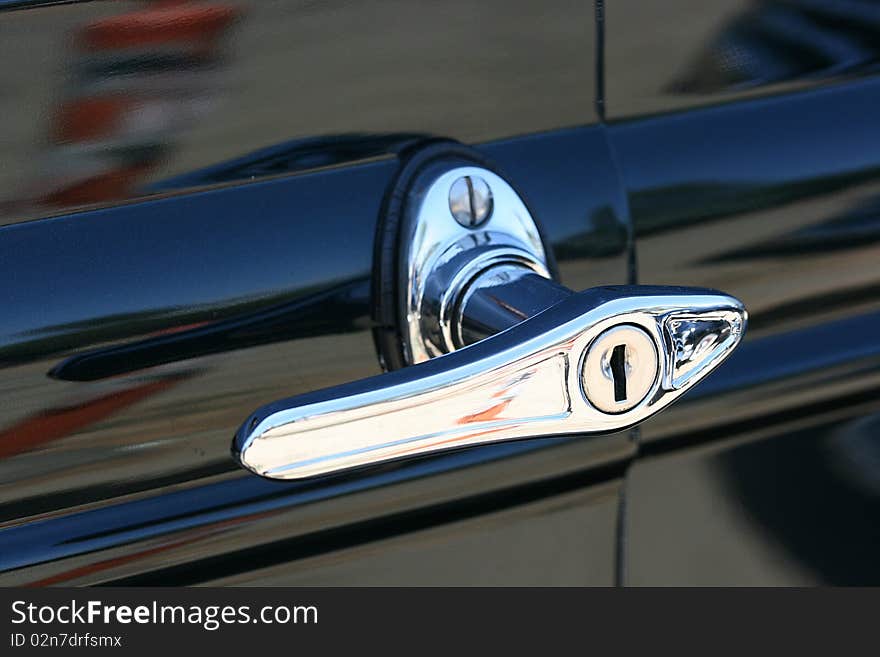 The handle on a door of the old car. The handle on a door of the old car.