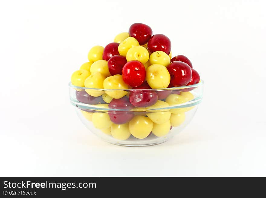 Red and yellow cherries isolated on white