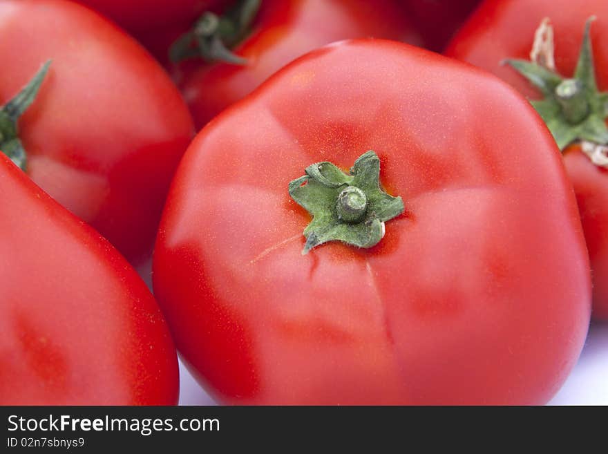 Isolated tomatoes, close up on white background