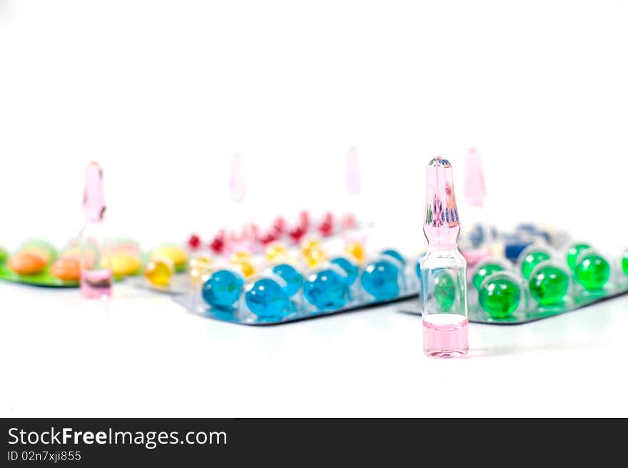 Various pills over white background