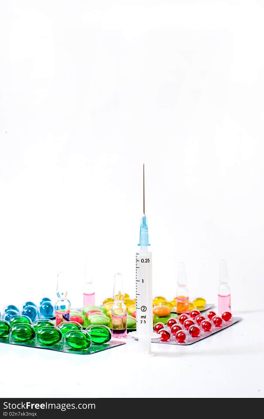 Various pills over white background