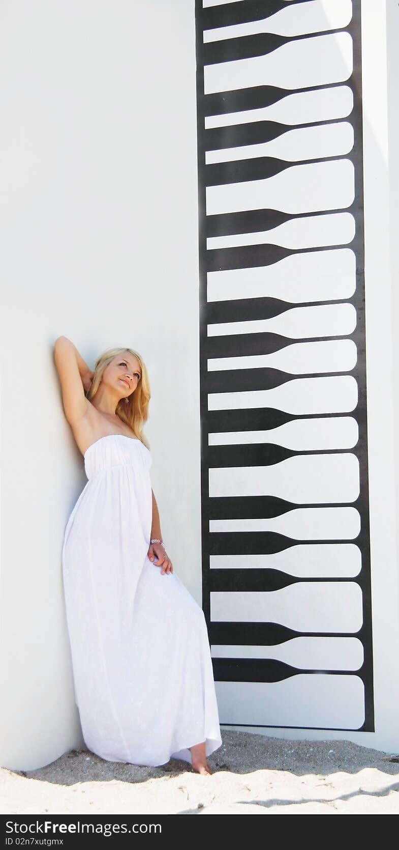 Girl posing next to drawn piano keyboard