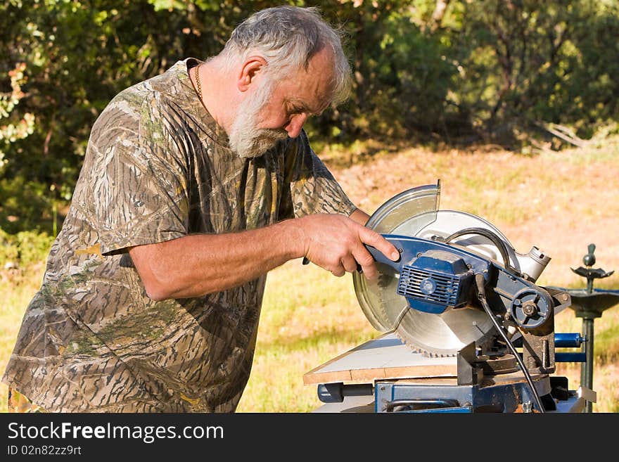 Senior Man Cutting Wood