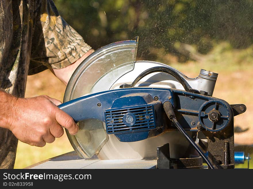 Man cutting wood with an electric saw. Man cutting wood with an electric saw.