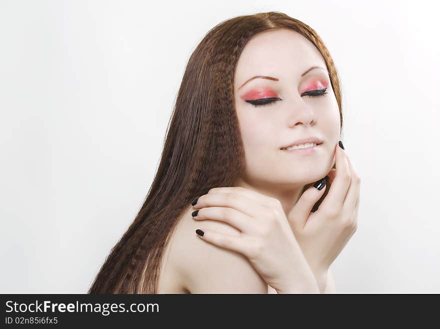 Close-up portrait of a young, beautiful caucasian woman with black nail polish and dark make-up