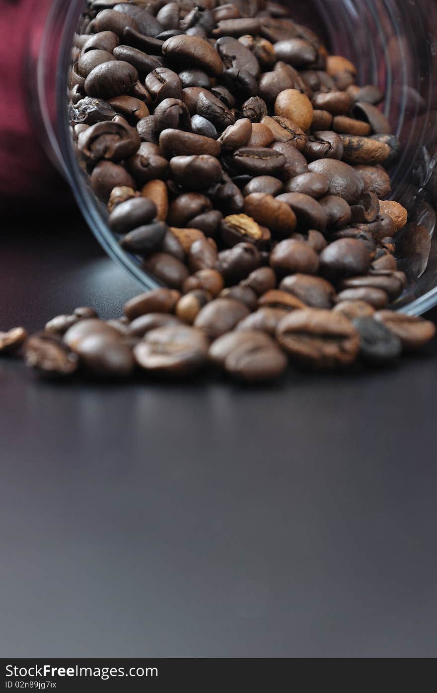 Pure glass with coffee granules on black table. Pure glass with coffee granules on black table