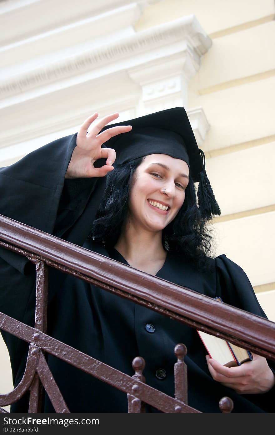 Young Student In Gown With Okay