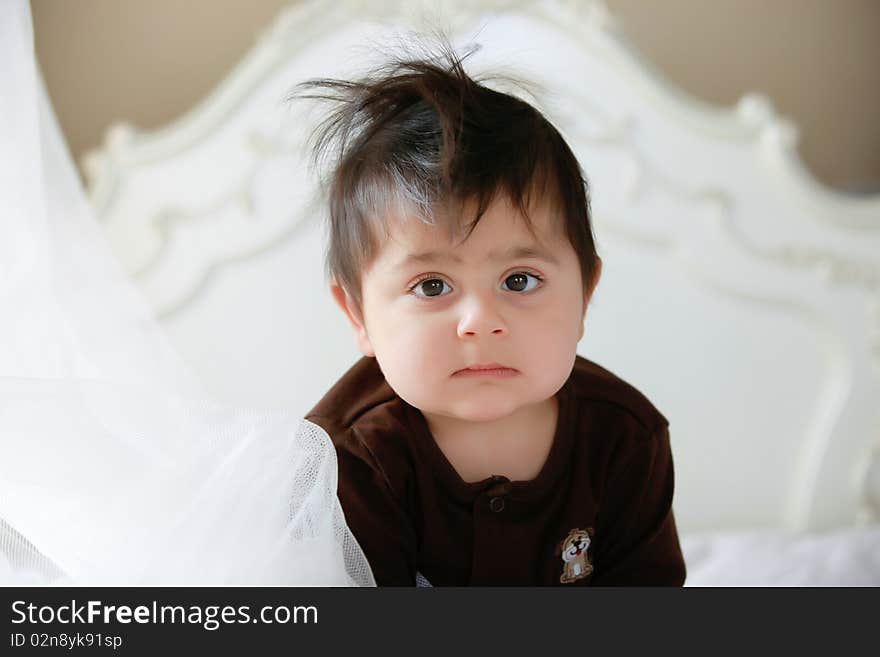 Little baby in bed after waking up from his nap.