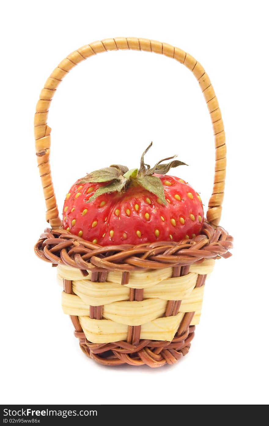 A fresh strawberry in a tiny basket isolated on a white background. A fresh strawberry in a tiny basket isolated on a white background