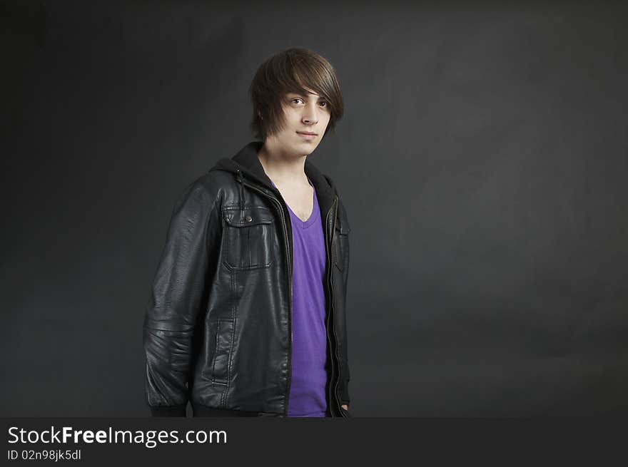 A young adult upper body pose wearing a leather jacket. A young adult upper body pose wearing a leather jacket