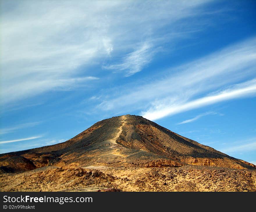 Mountaineering trail road going up to blue sky over sand desert mountain area ascending in Egypt, Africa. Mountaineering trail road going up to blue sky over sand desert mountain area ascending in Egypt, Africa