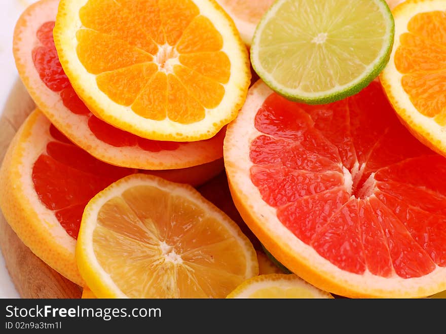 Slices of five various citruses background