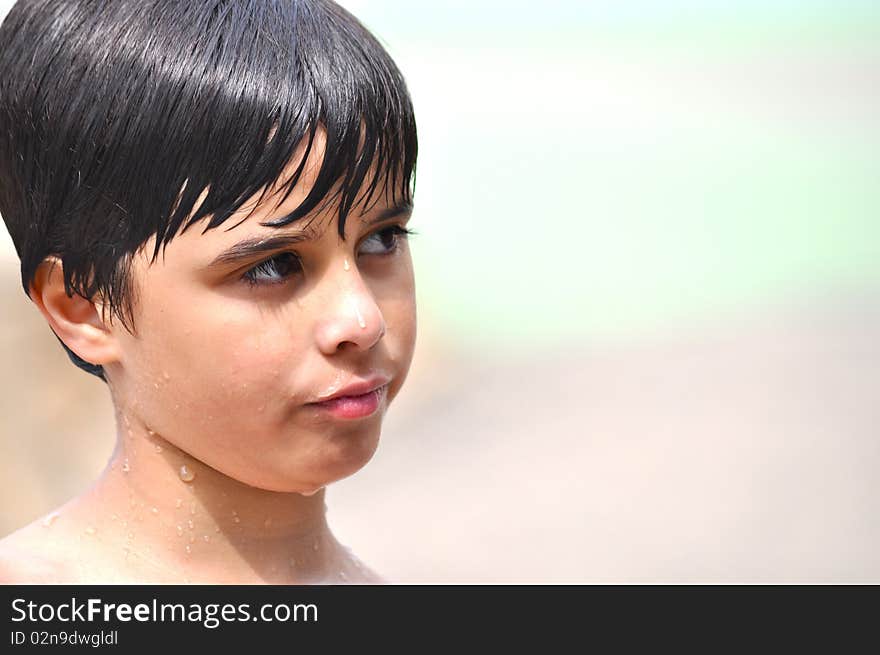 An adorable little boy is looking to the side with a confused expression in his face. An adorable little boy is looking to the side with a confused expression in his face.