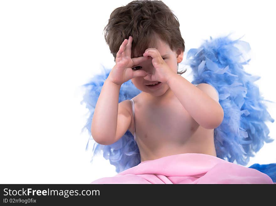 Boy with angel wings posing on a white background. Boy with angel wings posing on a white background