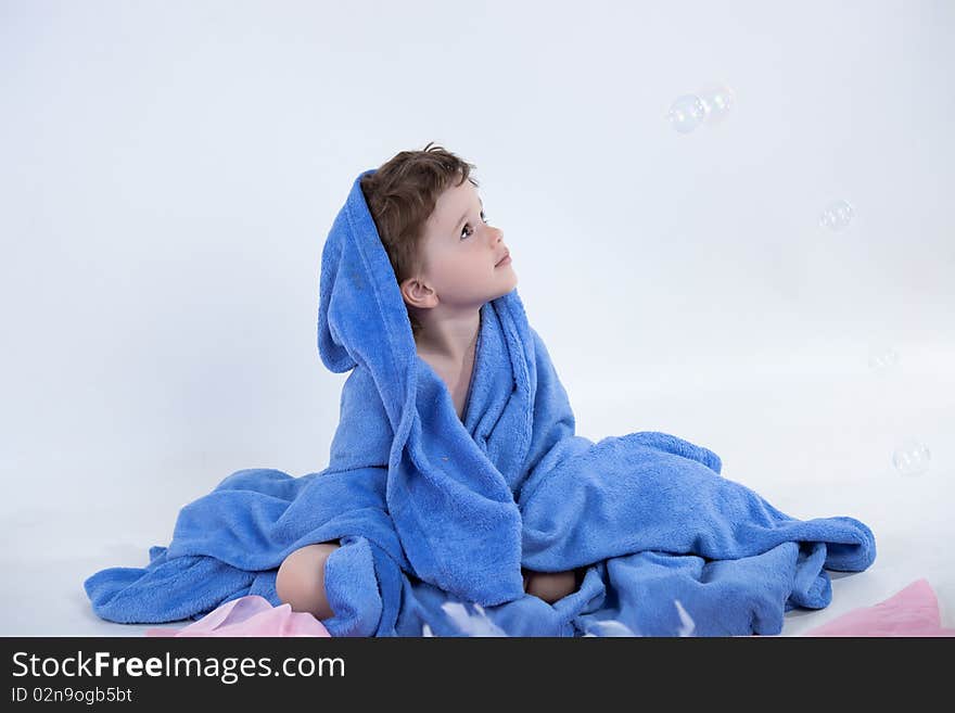 Little boy in towel looking away. Little boy in towel looking away