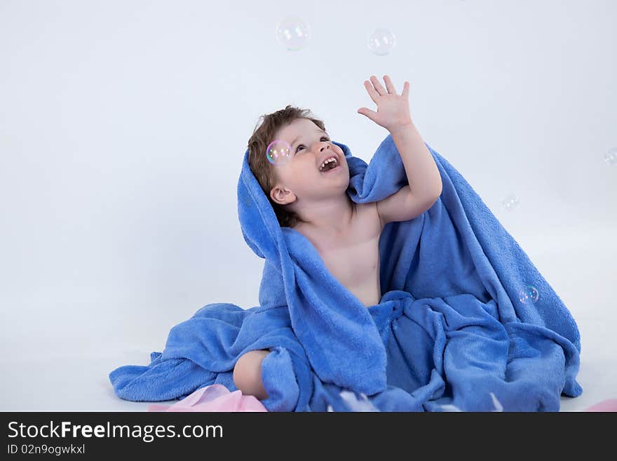 Little boy in towel looking away. Little boy in towel looking away