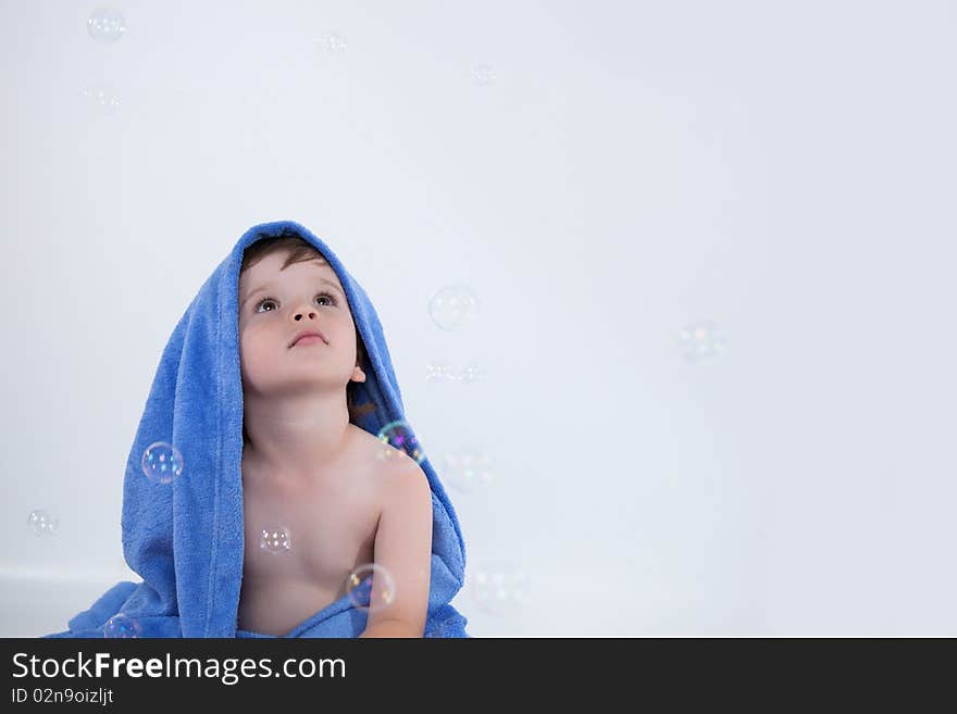 Little boy in towel looking away. Little boy in towel looking away