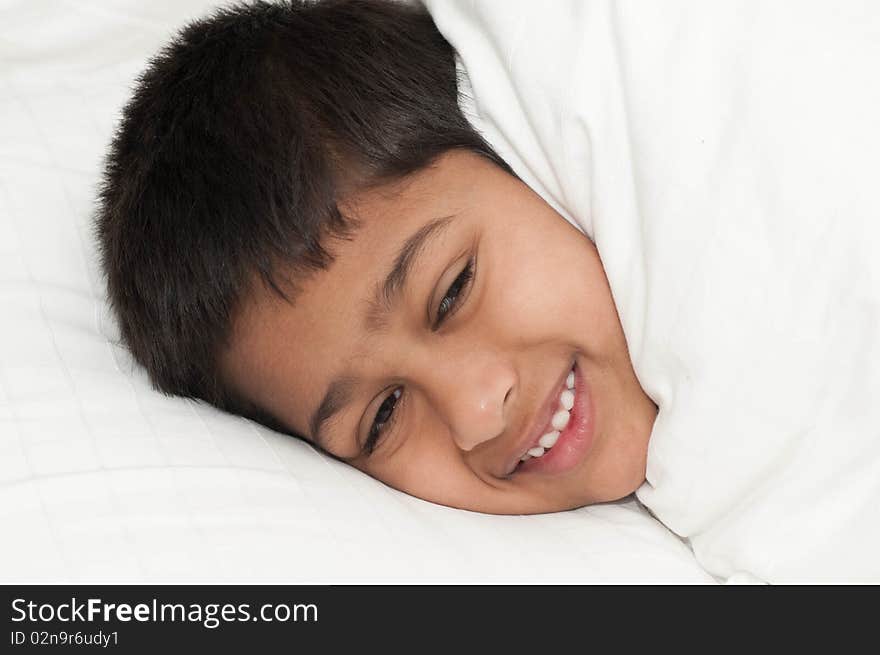 A handsome indian kid smiling for you