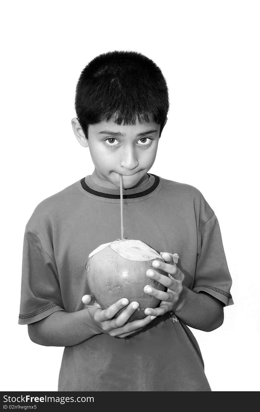 An handsome Indian kid drinking coconut water to cool off