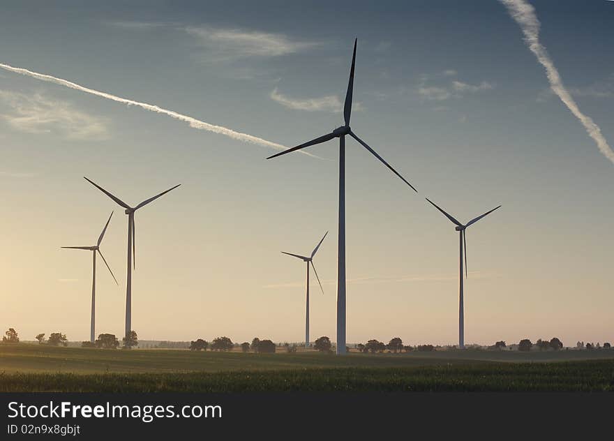 Wind turbine on sunset background