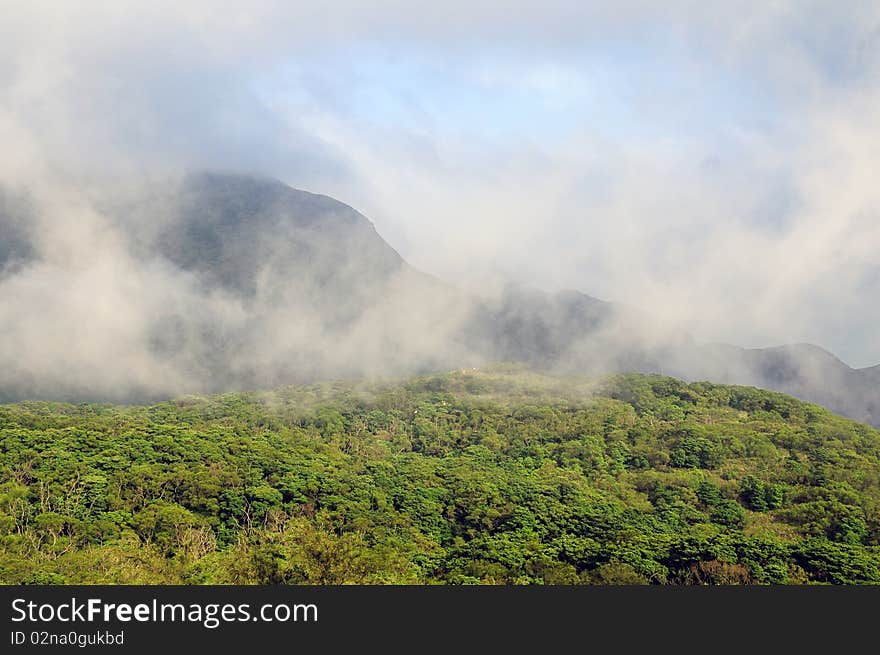 Lush green mountains and low hanging clouds. Lush green mountains and low hanging clouds