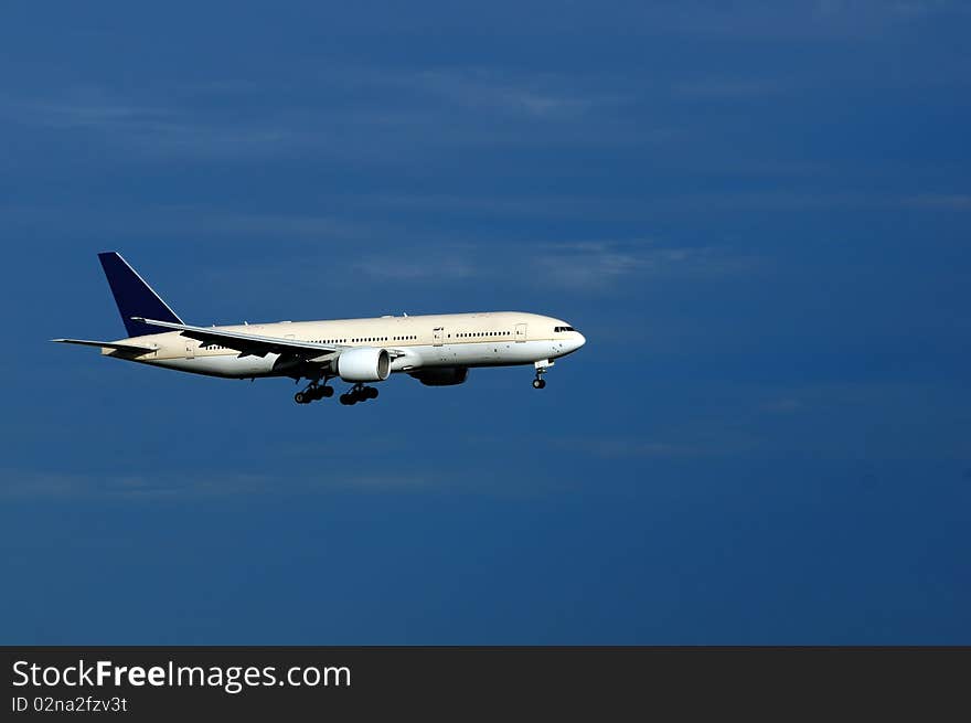 An aeroplane with landing gears switched on and ready to land