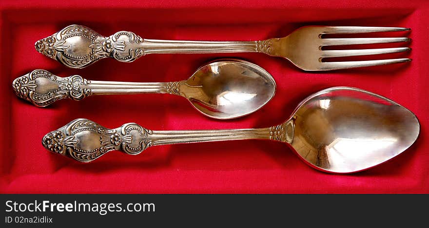 Silver tablewares on red background