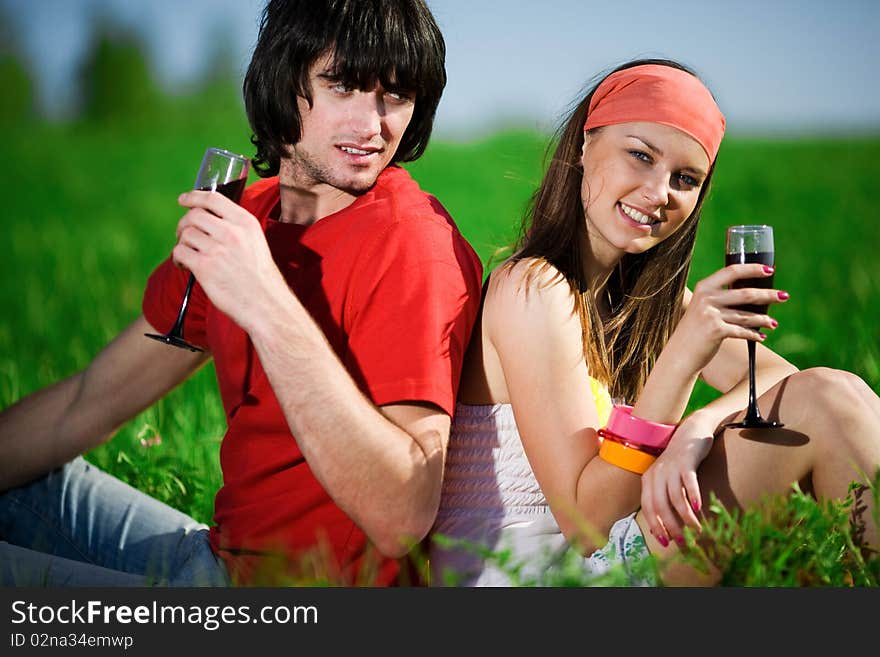 Boy With Girl And With Wineglasses On Grass