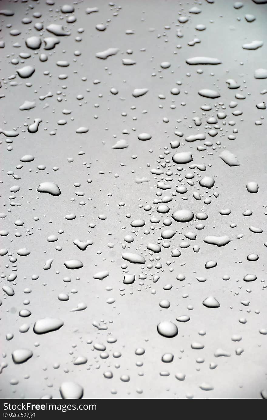 Rain drops on the glass of a car