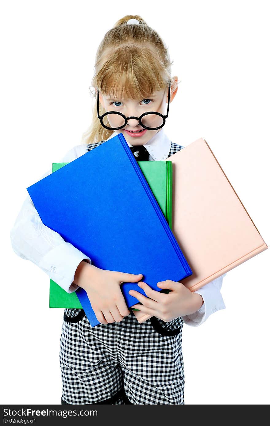 Shot of a little girl in glasses standing with books. Isolated over white background. Shot of a little girl in glasses standing with books. Isolated over white background.