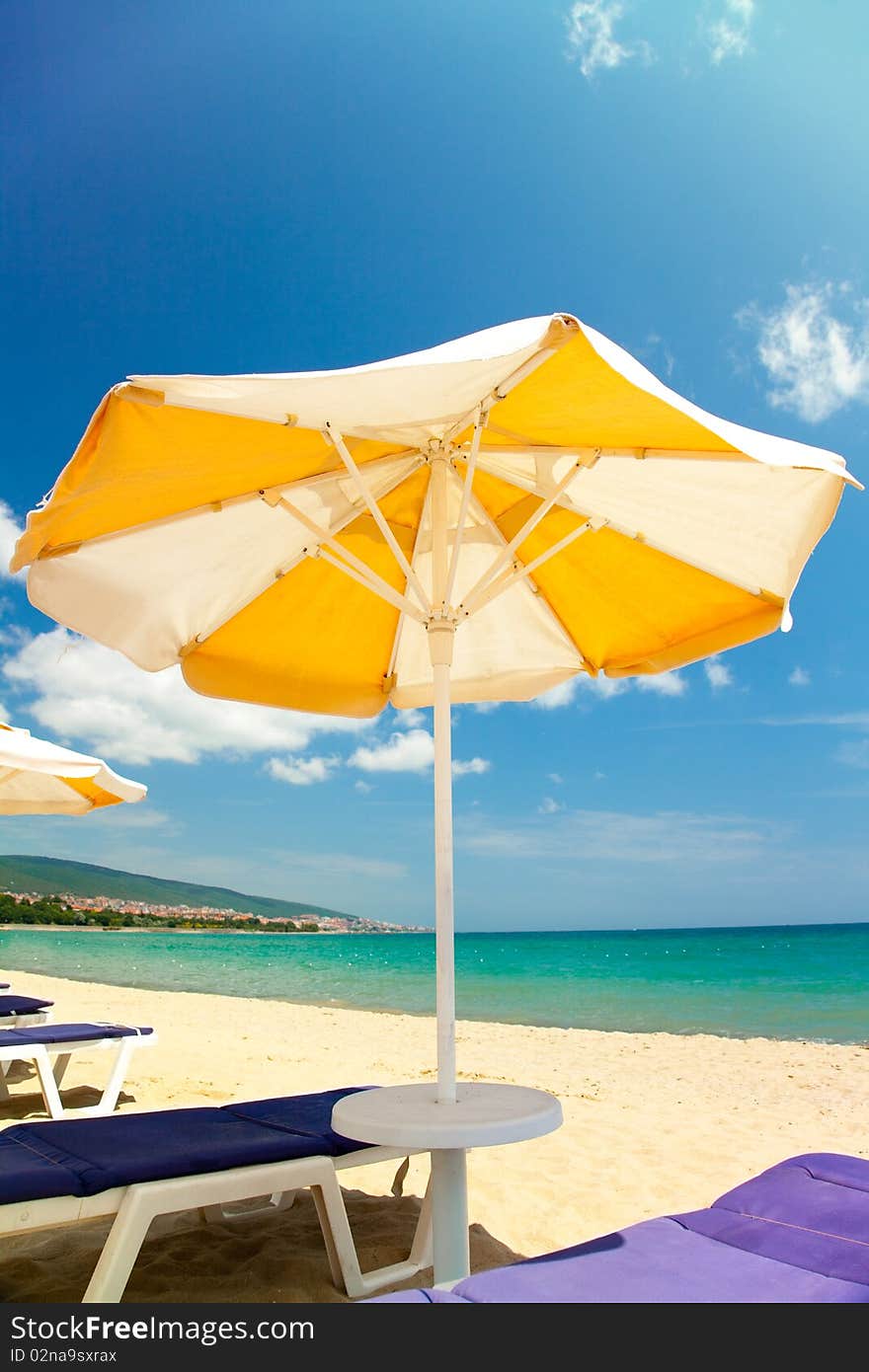 Bright umbrellas and chairs on beautiful tropical beach