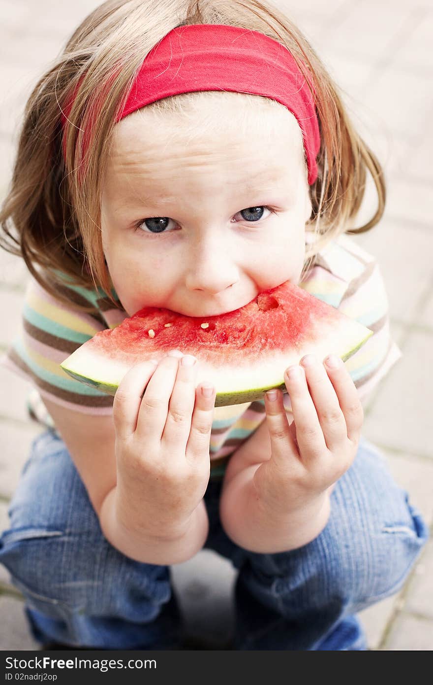 Girl squats and eats watermelon. Girl squats and eats watermelon