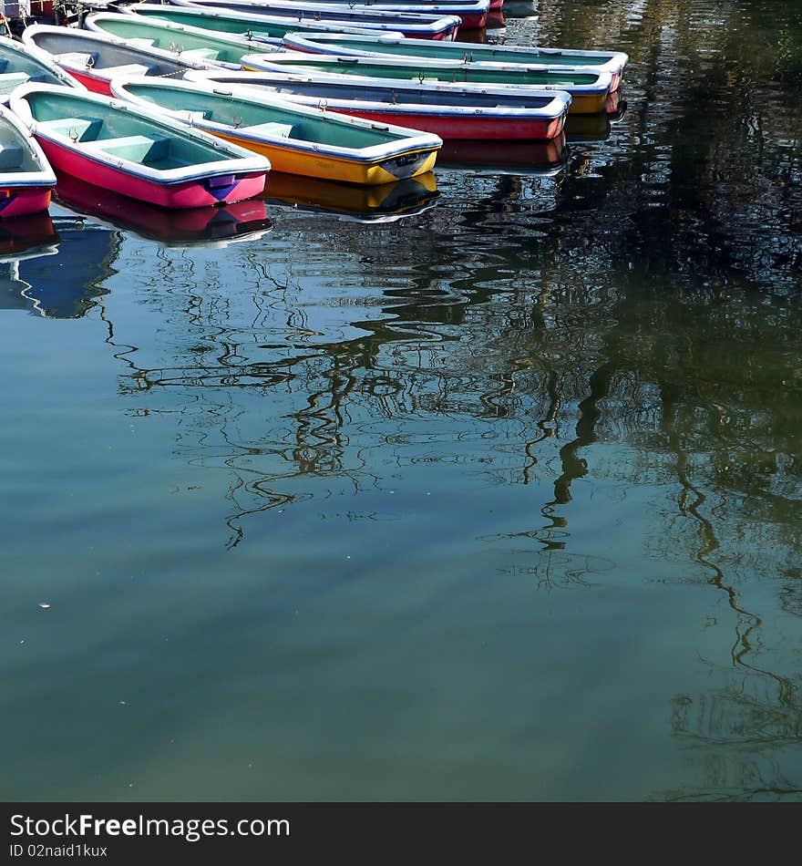 Boats on a pond in a park in Tokyo. Taken on a sunny Saturday.