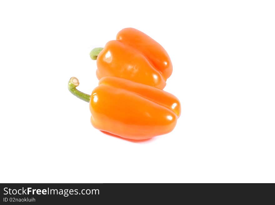 Two orange sweet peppers isolated over white background