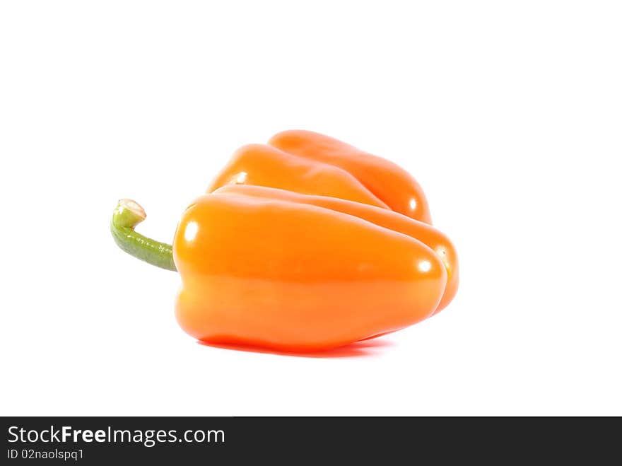 Two orange sweet peppers isolated over white background. Two orange sweet peppers isolated over white background