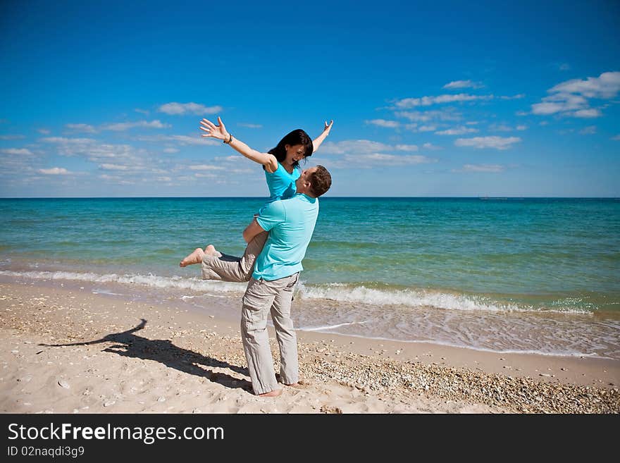 A couple on beach have fun