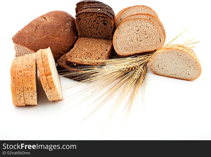 Various sorts of bread and spikes on white background. Various sorts of bread and spikes on white background