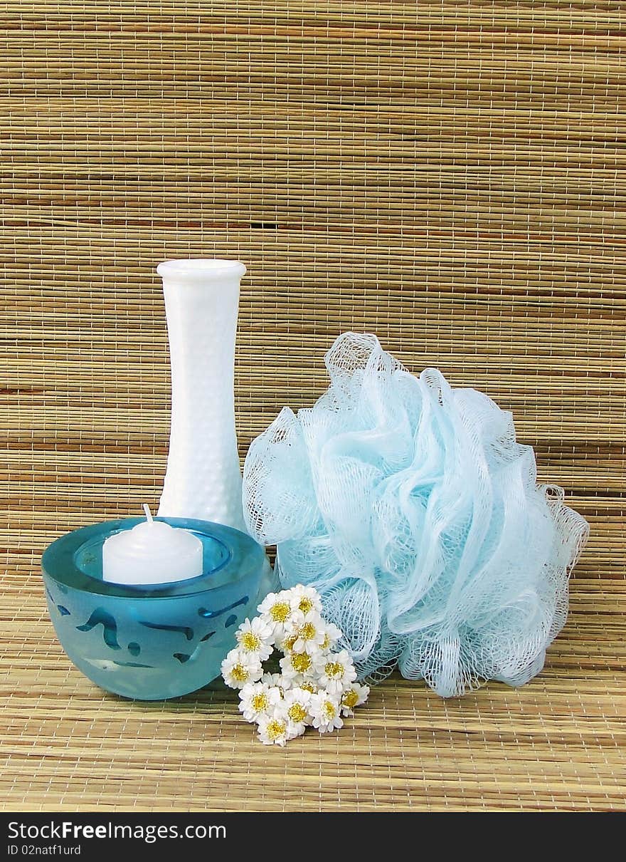 Bath sponge, votive candle, vase and flowers. Bath sponge, votive candle, vase and flowers