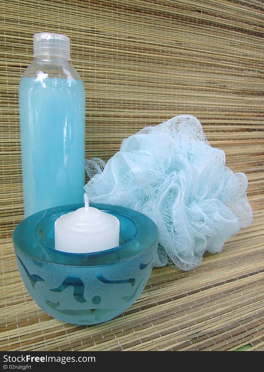 Blue bottle, bath sponge and votive candle. Blue bottle, bath sponge and votive candle