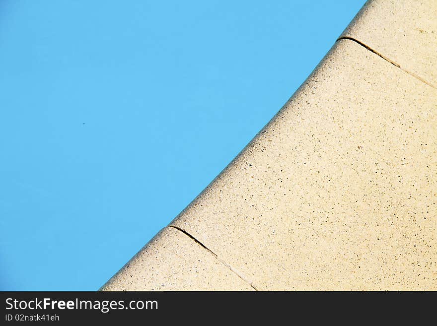 Edge of the swimming pool tiled with stone. Edge of the swimming pool tiled with stone