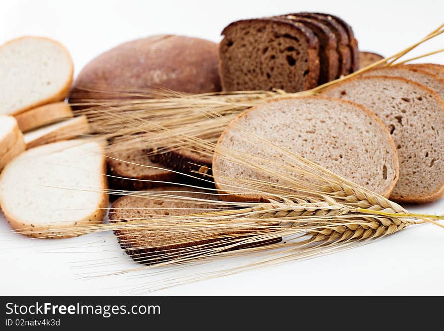 Various sorts of bread and spikes on white background