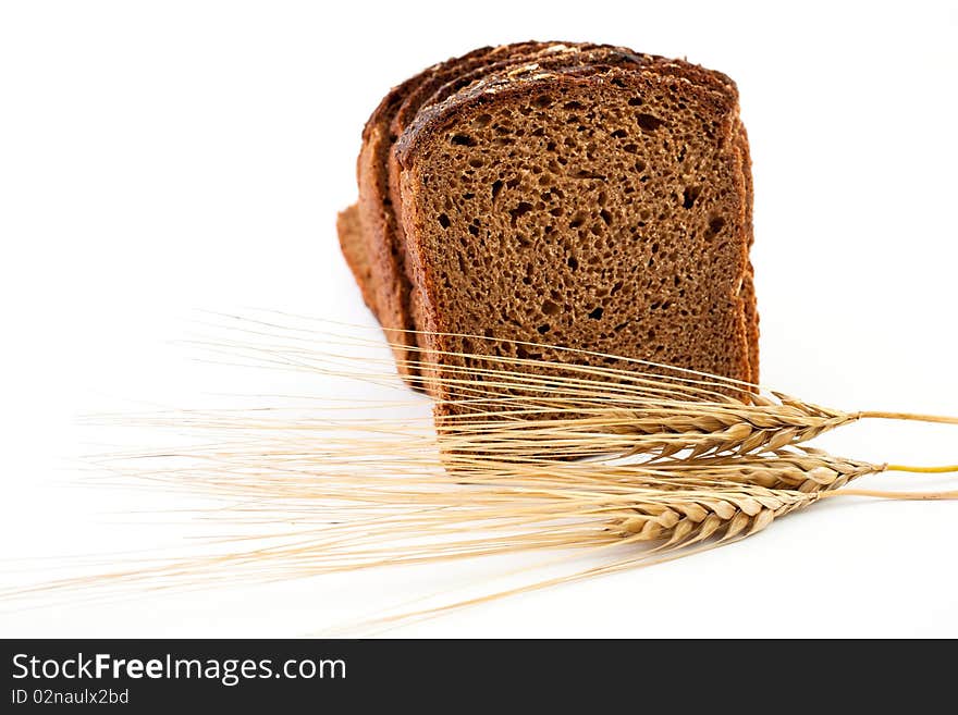 Various sorts of bread and spikes on white background. Various sorts of bread and spikes on white background