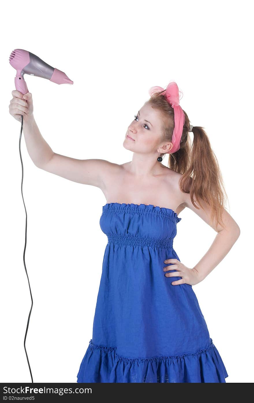 Red-haired girl with the hair dryer. Isolated over white .