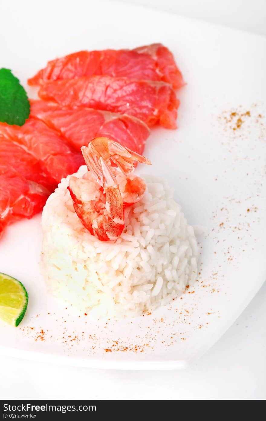 Rice with prawn and salmon on white plate. Rice with prawn and salmon on white plate