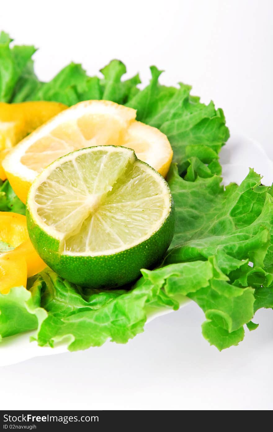 Various lemons with lettuce on white plate