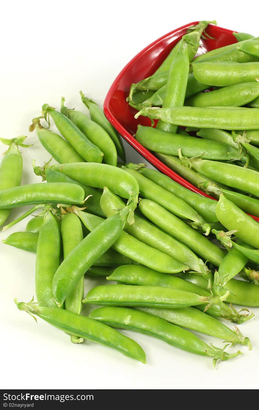 Delicious fresh green peas on white. Delicious fresh green peas on white