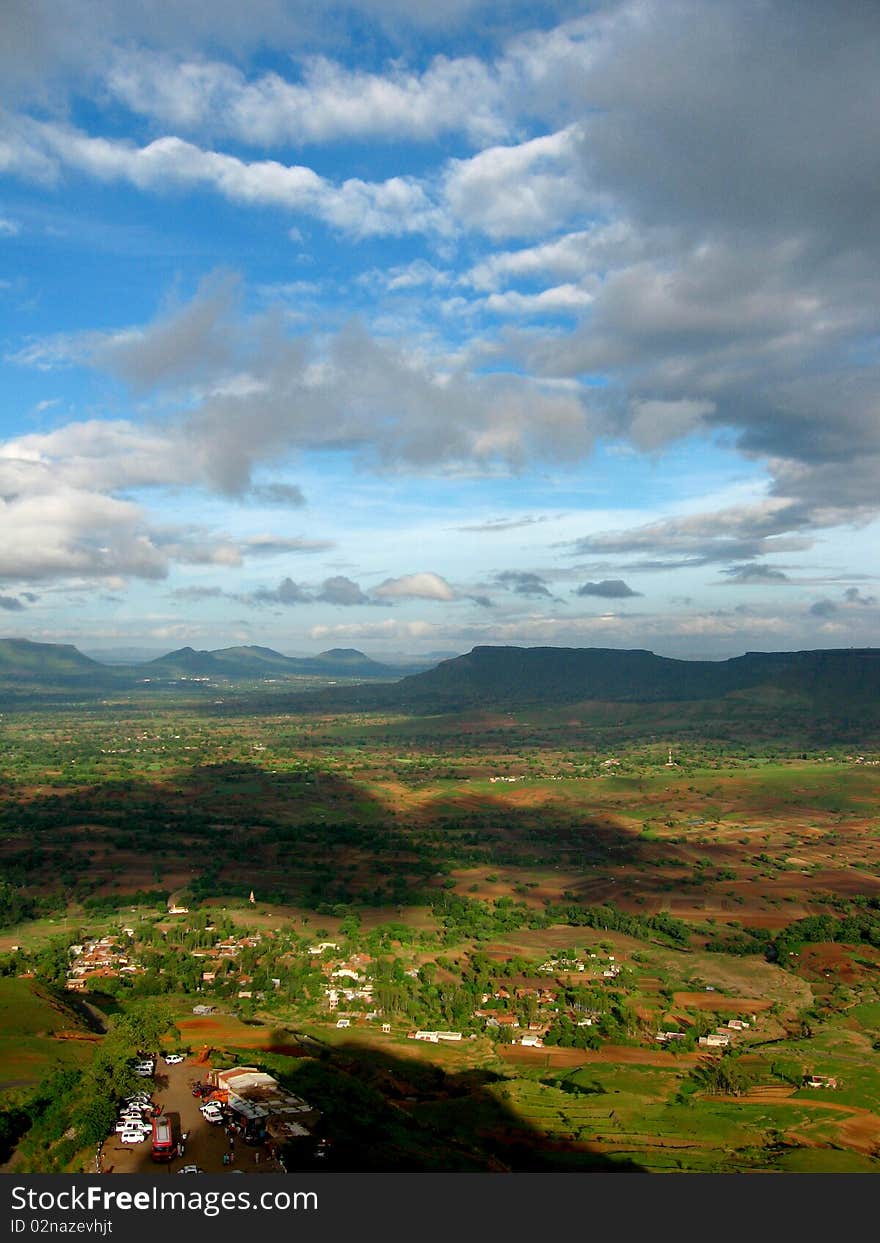 A beautiful view of dark Indian landscape with monsoon clouds hanging over. A beautiful view of dark Indian landscape with monsoon clouds hanging over.