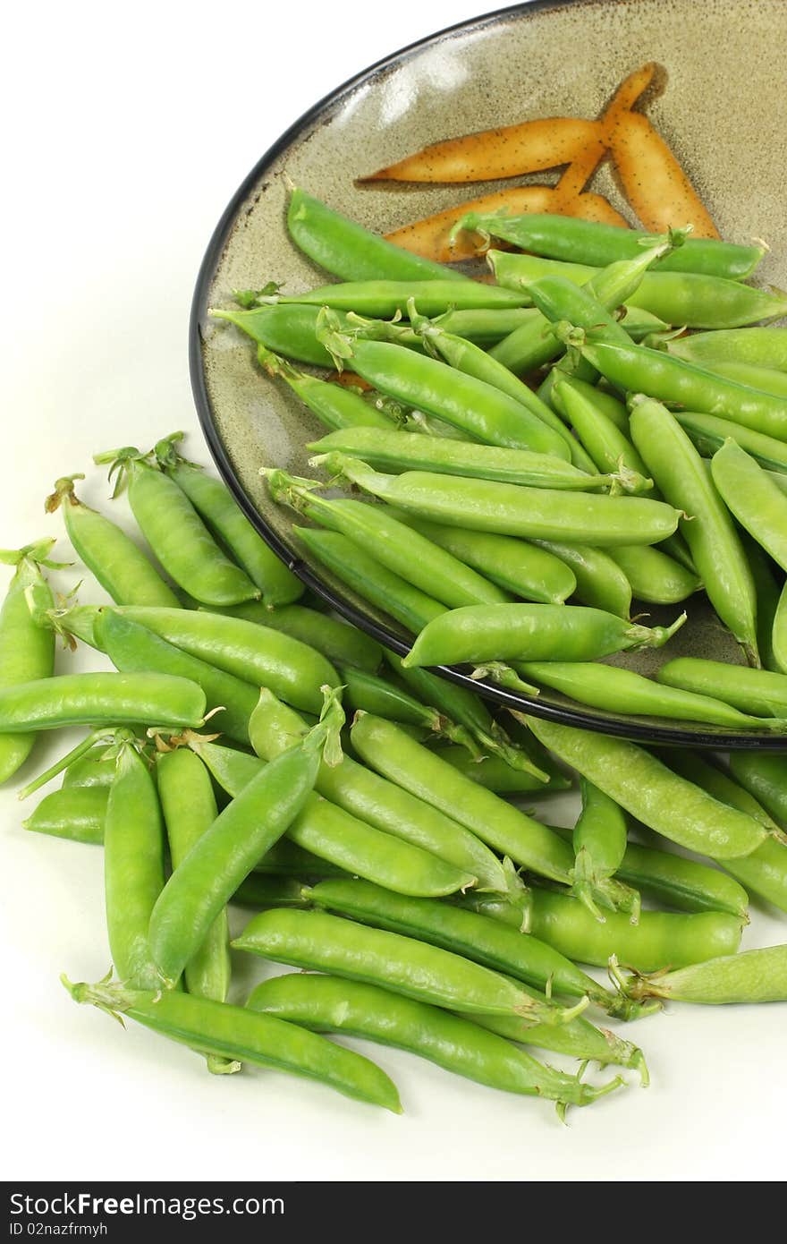 Delicious fresh green peas on white